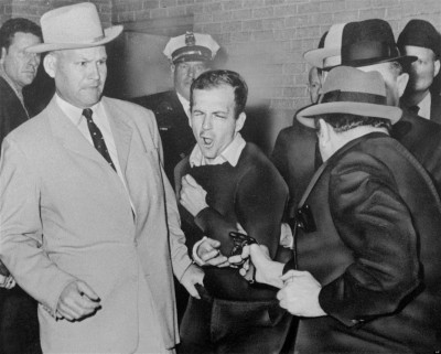 FILE - In this Nov. 24, 1963 file photo, Lee Harvey Oswald, accused assassin of President John F. Kennedy, reacts as Dallas night club owner Jack Ruby, foreground, shoots at him from point blank range in a corridor of Dallas police headquarters. For most Americans media coverage of the accused leaving police precincts isnt unusual but some French politicians and citizens were disturbed this week when a rumpled, handcuffed, angry-looking Dominique Strauss-Kahn was shown being escorted by New York police after being accused of sexual abuse. (AP Photo/Dallas Times-Herald, Bob Jackson, File)